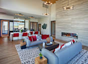 Thumbnail 29 of 35 - A modern living room with a fireplace and a grey couch.