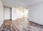 Thumbnail 22 of 29 - A room with wooden flooring and white walls.