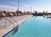 Thumbnail 22 of 35 - A long rectangular pool with a metal ladder on the side.