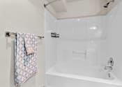 Thumbnail 23 of 28 - the bathroom has a shower and a sink and a towel