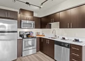 Thumbnail 22 of 28 - a kitchen with stainless steel appliances and wooden cabinets