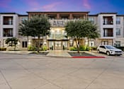 Thumbnail 1 of 33 - A white car is parked in front of a building named Axis.