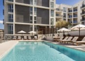Thumbnail 1 of 28 - Apartments in Hollywood CA - The Fifty Five Fifty - Sparkling Pool Surrounded by Lounge Seating