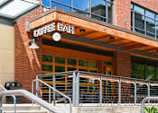 Thumbnail 32 of 35 - A coffee bar with a wooden awning and glass windows.