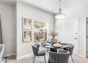 Thumbnail 1 of 27 - A dining room with a table set for four.