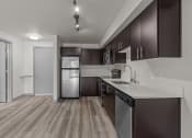 Thumbnail 17 of 28 - a kitchen with white countertops and a stainless steel refrigerator