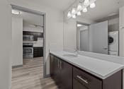 Thumbnail 25 of 28 - a kitchen with a large mirror and a white counter top