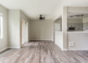 Thumbnail 11 of 43 - an empty living room with a ceiling fan
