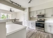 Thumbnail 1 of 43 - a kitchen with white cabinets and a white counter top