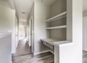 Thumbnail 12 of 43 - a bedroom with a desk and shelves