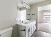 Thumbnail 13 of 43 - a bathroom with a large mirror and two sinks