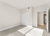 Thumbnail 44 of 58 - a living room with a rug and a door to a kitchen