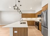 Thumbnail 33 of 58 - a kitchen with wooden cabinets and stainless steel appliances