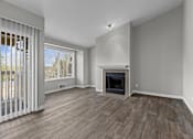 Thumbnail 18 of 32 - an empty living room with a fireplace and a window