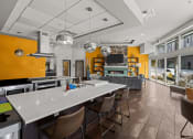 Thumbnail 13 of 28 - a kitchen with a long counter and chairs and a living room