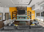 Thumbnail 9 of 28 - a living room with a large couch and a fireplace