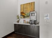 Thumbnail 10 of 28 - an office with a coffee machine and a counter with a painting on the wall