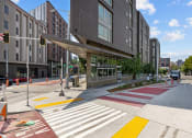Thumbnail 11 of 28 - a crosswalk in front of a building on a city street