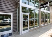 Thumbnail 28 of 28 - the facade of a car dealership with cars in the window