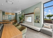Thumbnail 5 of 21 - a living room with a table and chairs and a large window