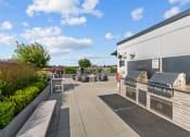 Thumbnail 9 of 21 - the outdoor patio of a home with a barbecue grill and seating