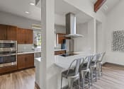 Thumbnail 22 of 43 - a kitchen with white countertops and wooden cabinets