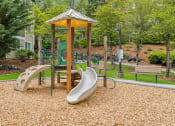 Thumbnail 30 of 43 - a playground with a swing set and slides
