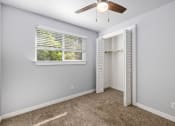Thumbnail 6 of 8 - North River Apartments bedroom with a ceiling fan and a window