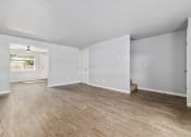 Thumbnail 2 of 8 - North River Apartments living room with white walls and wood floors