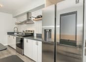 Thumbnail 4 of 33 - a kitchen with white cabinets and stainless steel appliances