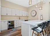 Thumbnail 4 of 10 - A kitchen with a white table and black chairs.