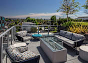 Thumbnail 3 of 35 - A patio with a glass table surrounded by chairs and couches.
