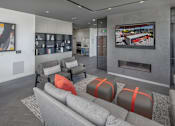 Thumbnail 24 of 35 - A modern living room with grey sofas and a fireplace.