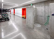 Thumbnail 27 of 35 - A bike wash area with a green hose.