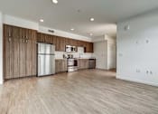 Thumbnail 12 of 21 - A kitchen with wooden cabinets and a stainless steel refrigerator.