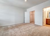 Thumbnail 9 of 21 - A room with a carpeted floor and a white door.