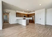 Thumbnail 20 of 21 - A kitchen with a white countertop and wooden cabinets.