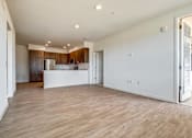 Thumbnail 21 of 21 - A spacious kitchen with wooden floors and white walls.