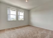 Thumbnail 15 of 21 - A room with a carpeted floor and two windows.