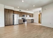 Thumbnail 18 of 21 - A kitchen with wooden cabinets and stainless steel appliances.