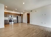Thumbnail 7 of 28 - A spacious kitchen with wooden floors and modern appliances.