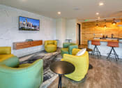 Thumbnail 15 of 48 - a living room with chairs and a bar and a television