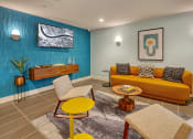 Thumbnail 14 of 48 - a living room with a yellow couch and a blue wall