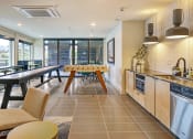 Thumbnail 16 of 48 - a kitchen and dining room with a table and chairs and a sink
