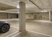 Thumbnail 29 of 48 - a parking garage with a car parked in it
