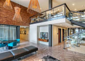 Thumbnail 30 of 48 - the lobby of a building with a staircase and a tv