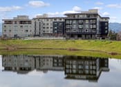 Thumbnail 47 of 48 - a building reflected in a body of water