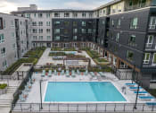 Thumbnail 11 of 48 - an aerial view of an apartment building with a swimming pool