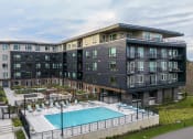 Thumbnail 48 of 48 - a large building with a swimming pool in front of it
