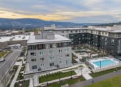 Thumbnail 42 of 48 - an aerial view of a large apartment building with a swimming pool
